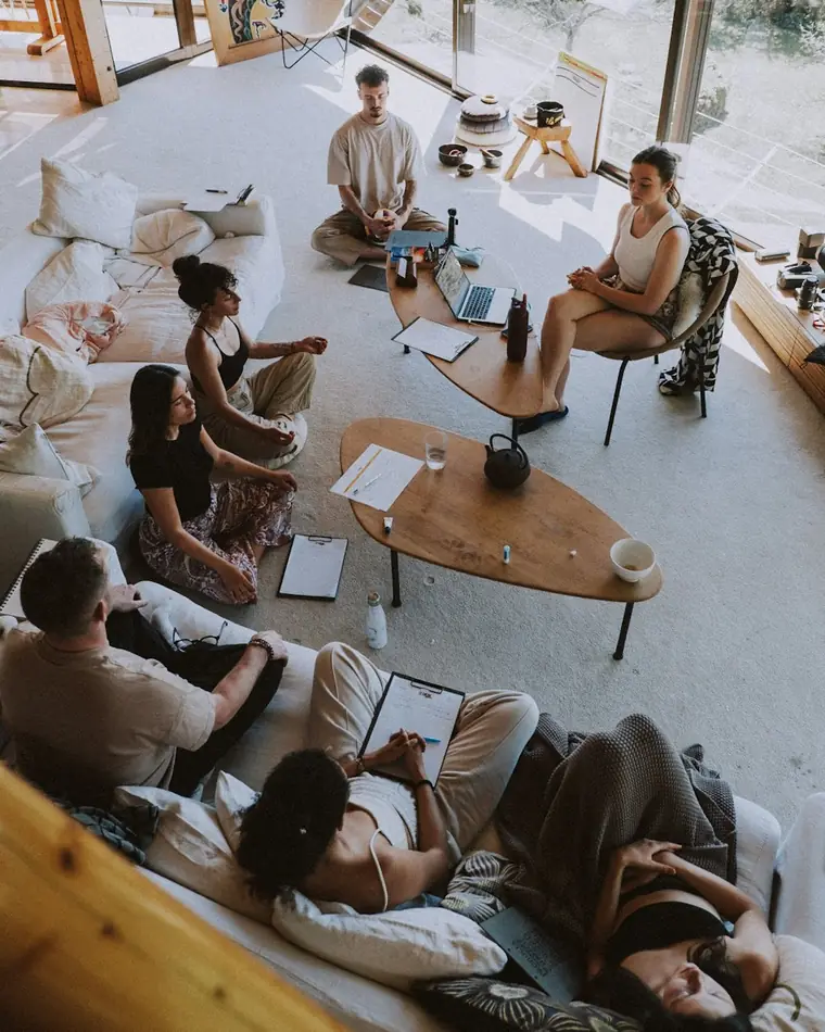 A small group meditating together in a bright, calm room